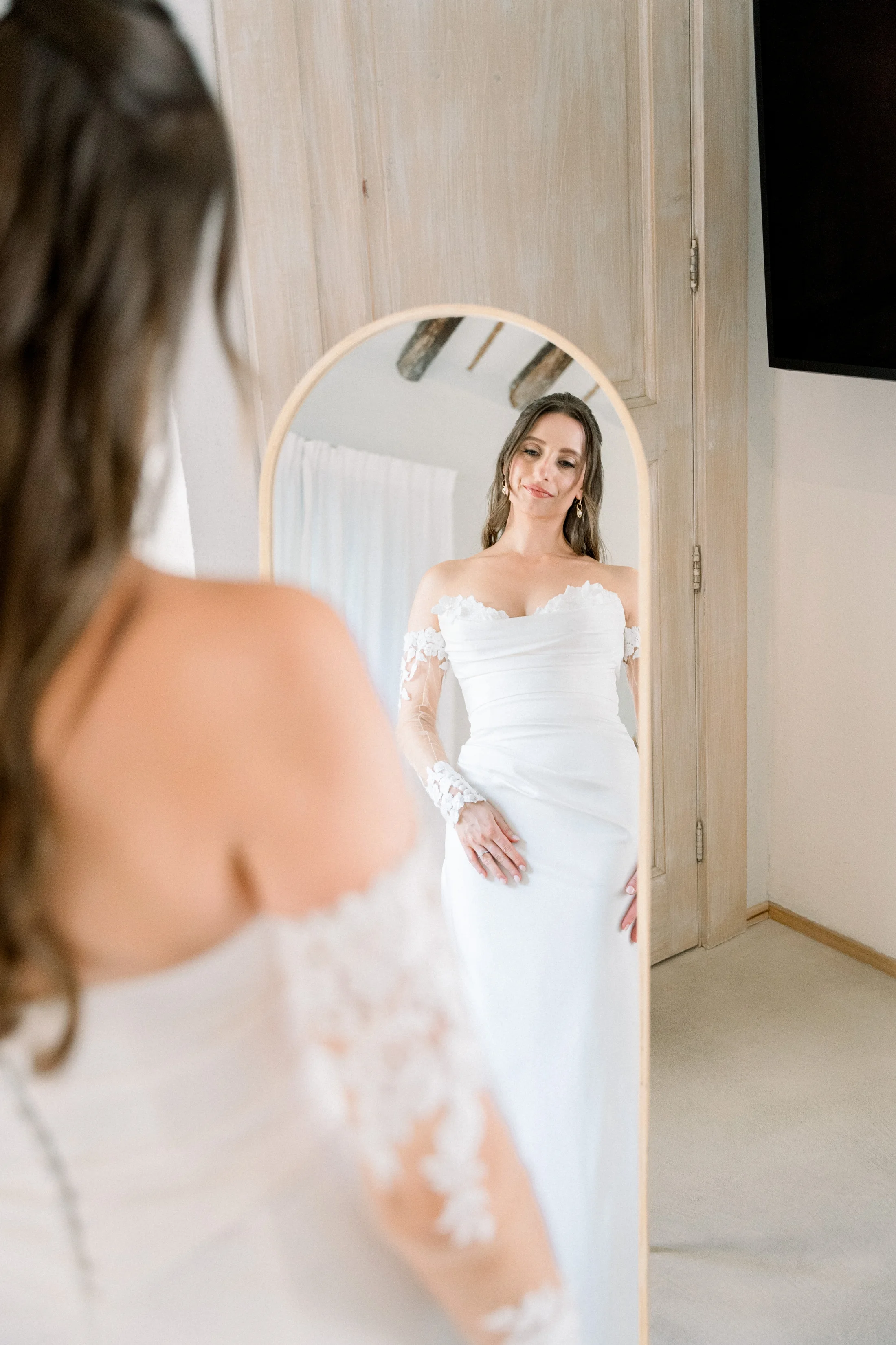 Bride reflected in a mirror during preparations