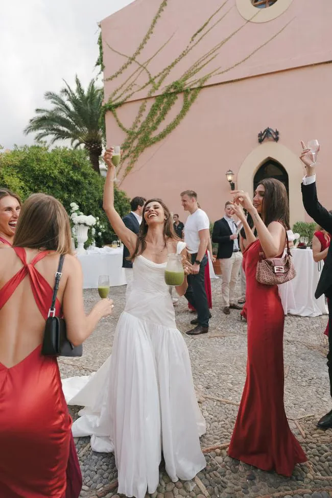 Bride greeted by guests in a courtyard