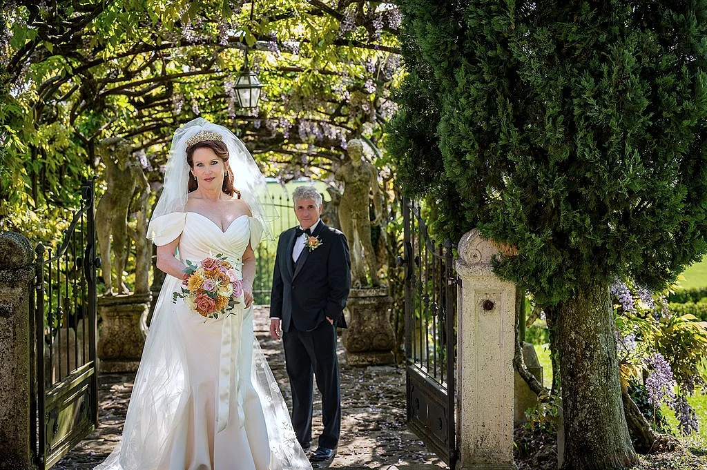 Bride and groom walking through a garden