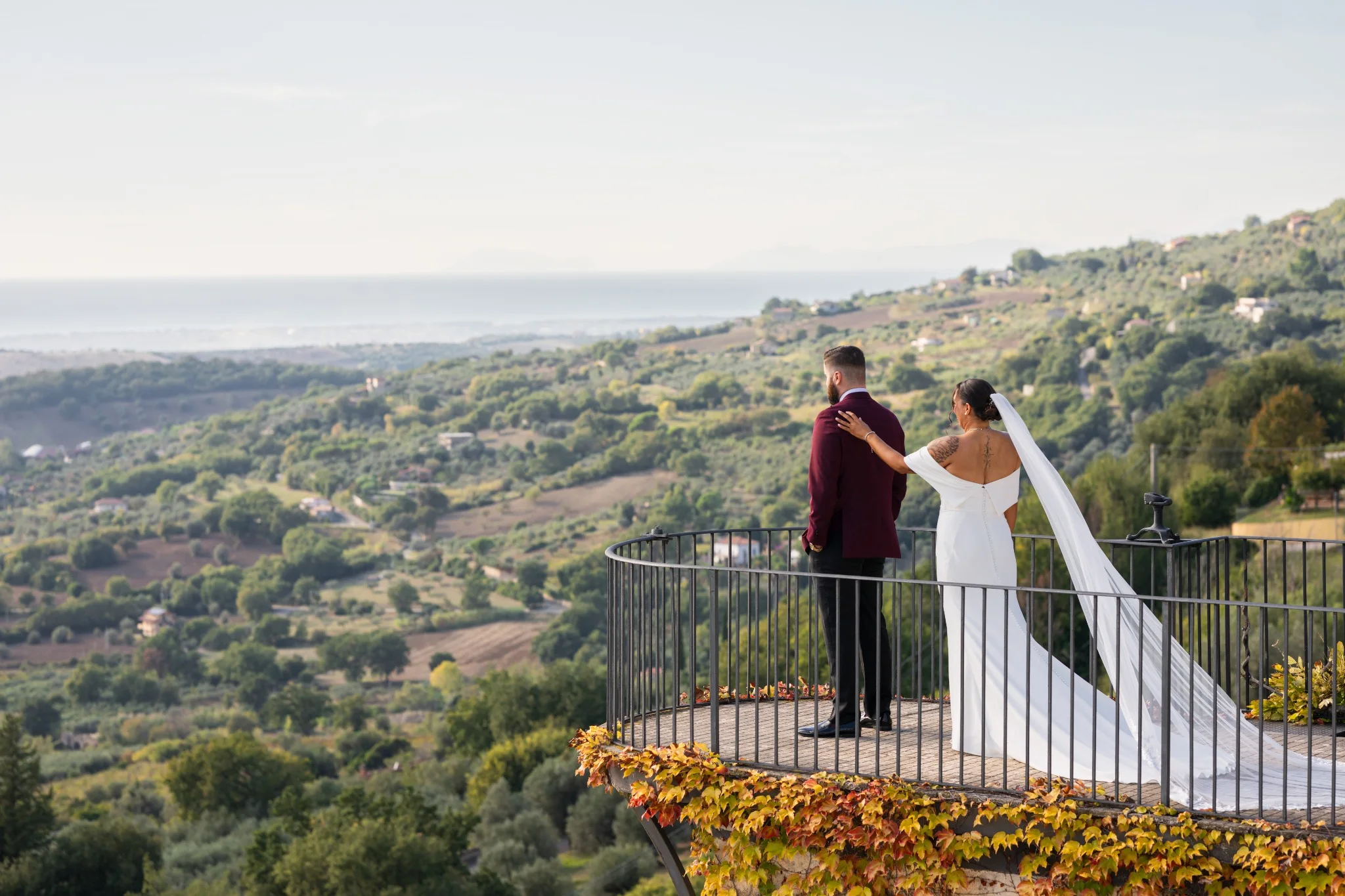 Bride and groom looking over a countryside terrace