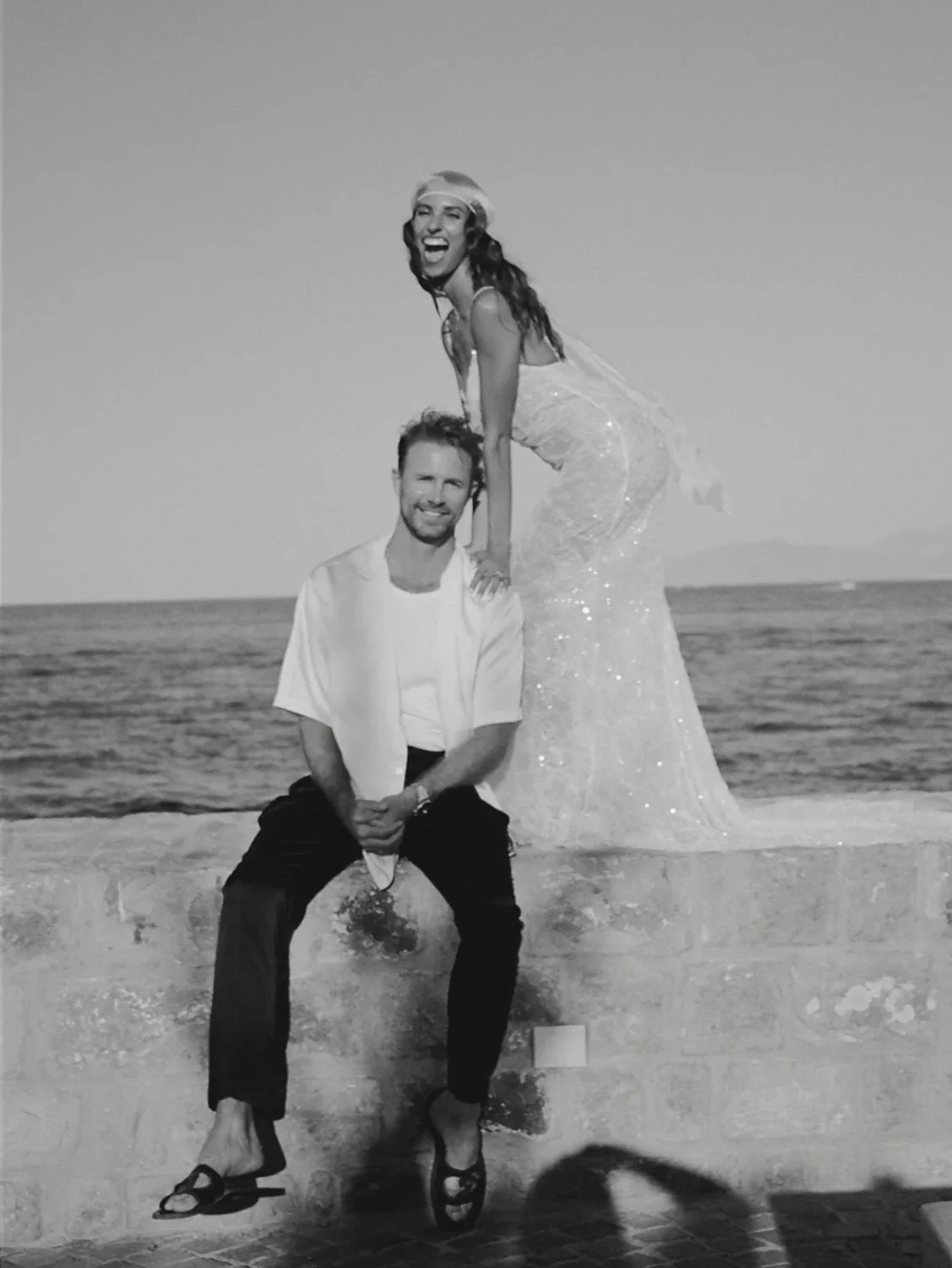 Black-and-white portrait of a couple beside the sea
