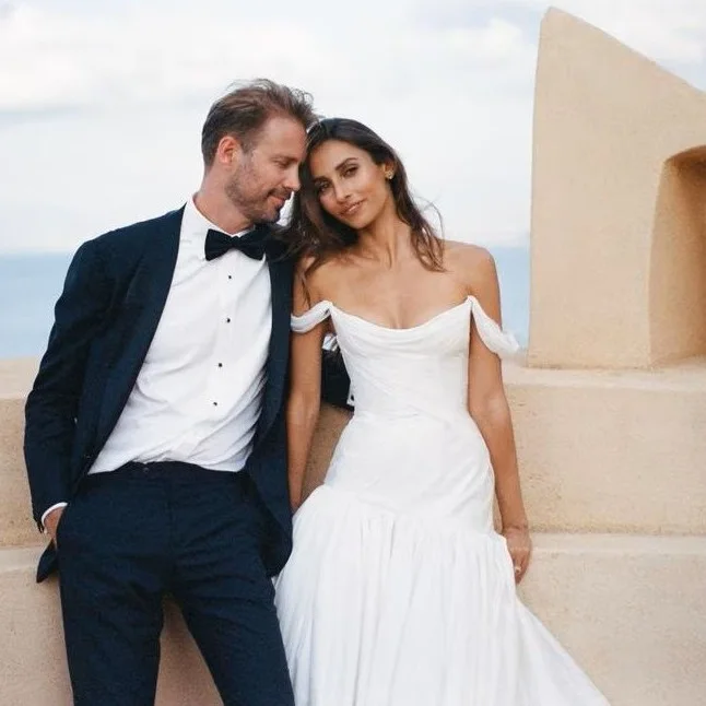 Bride and groom leaning together on a terrace