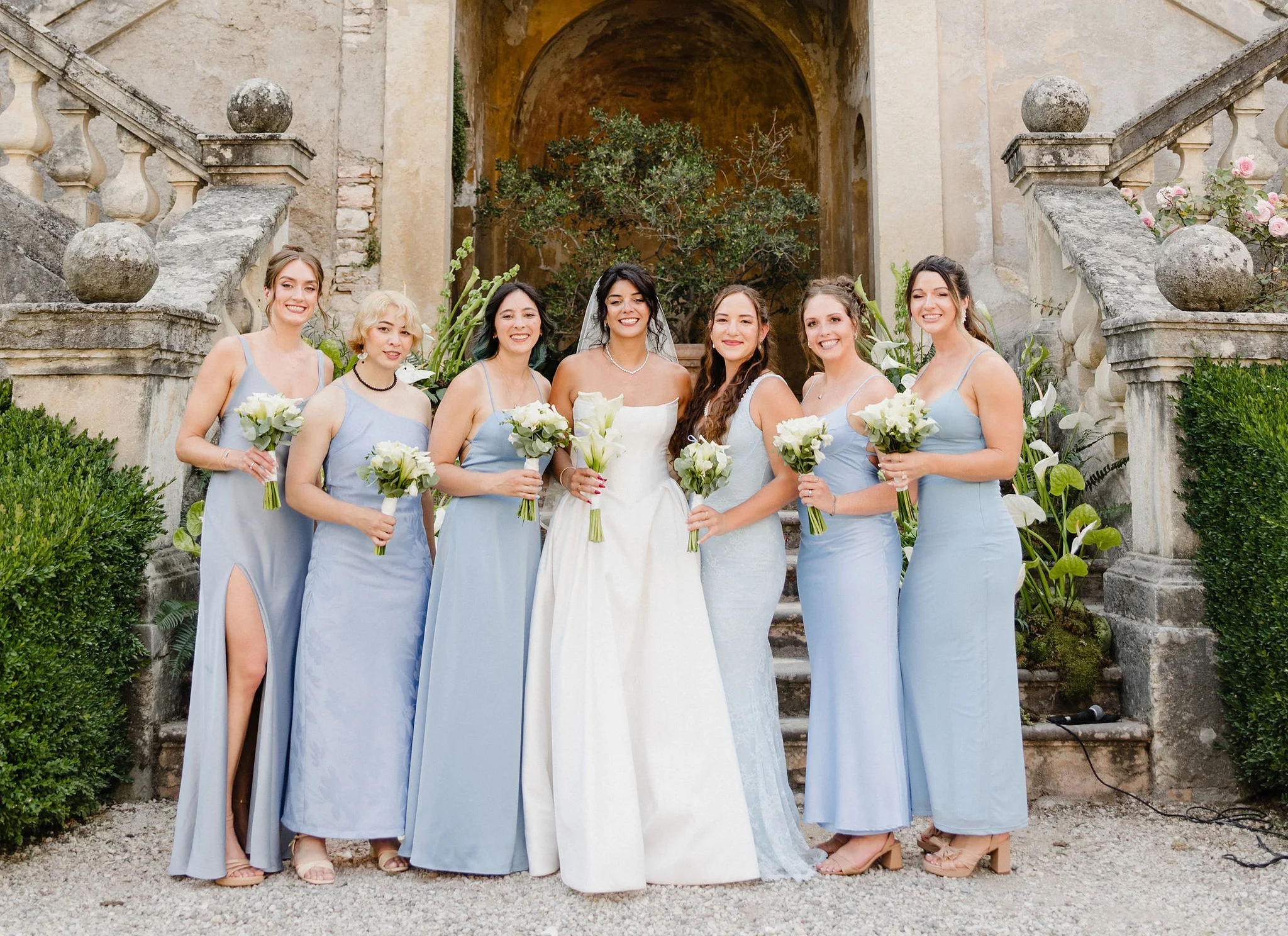Bride and bridesmaids on an outdoor staircase
