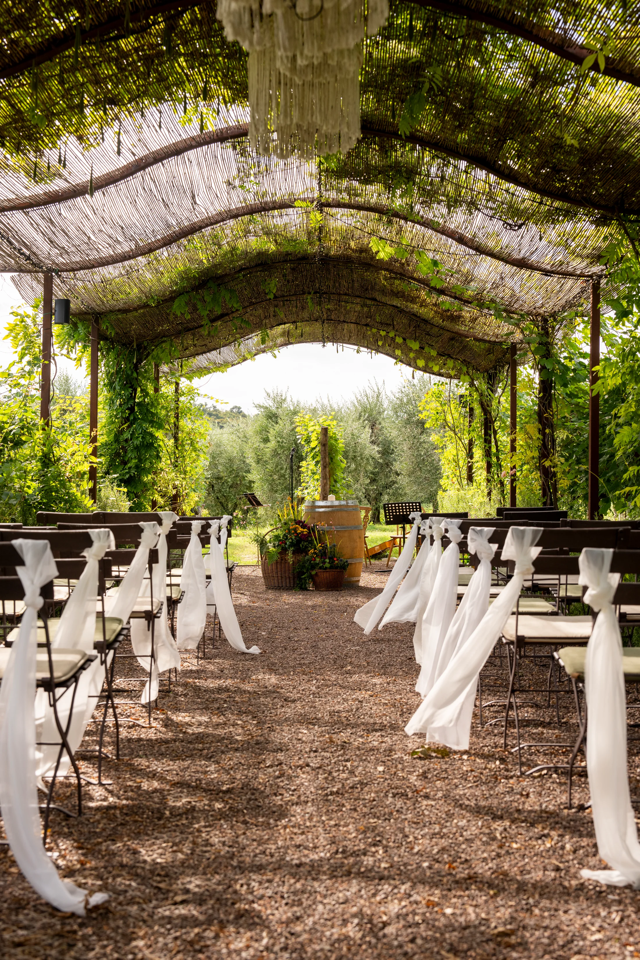 Ceremony chairs beneath a stone archway
