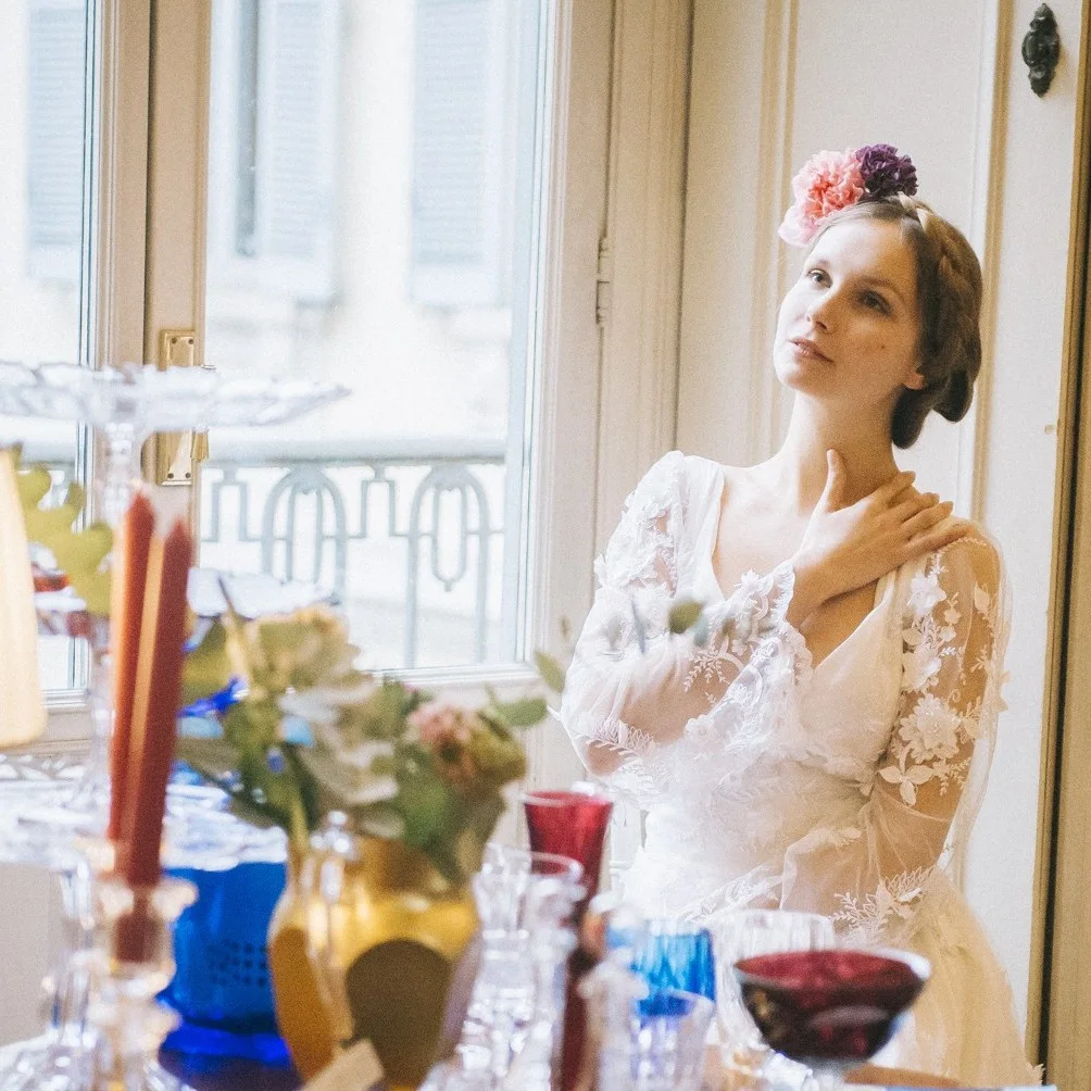 Bride preparing beside a tall window