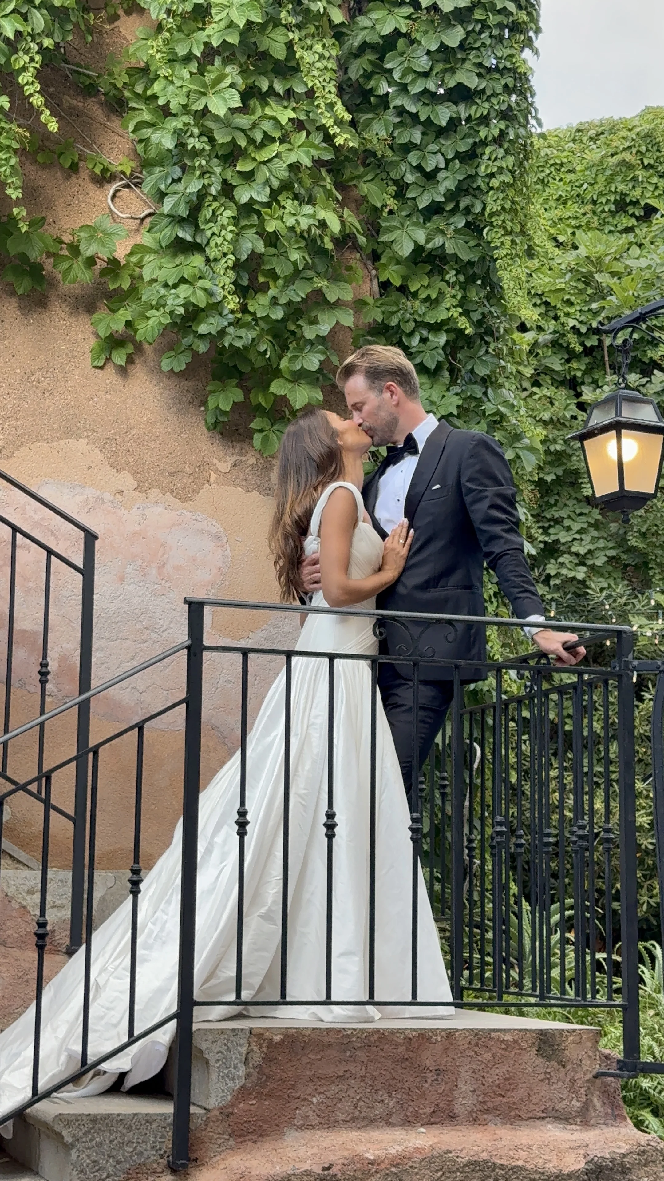 Bride and groom on an outdoor staircase