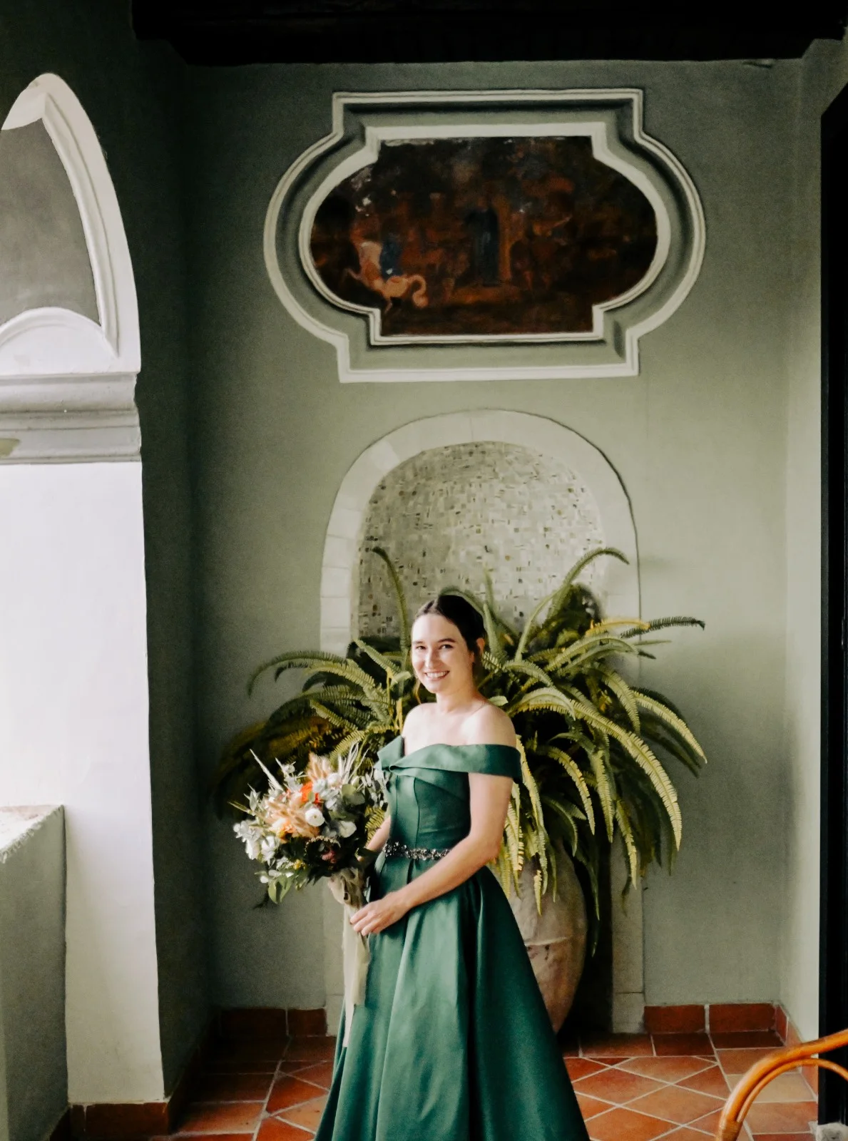 Woman in a green dress in an ornate interior