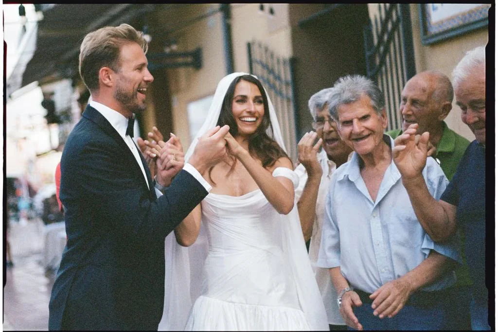 Wedding guests applauding the bride and groom
