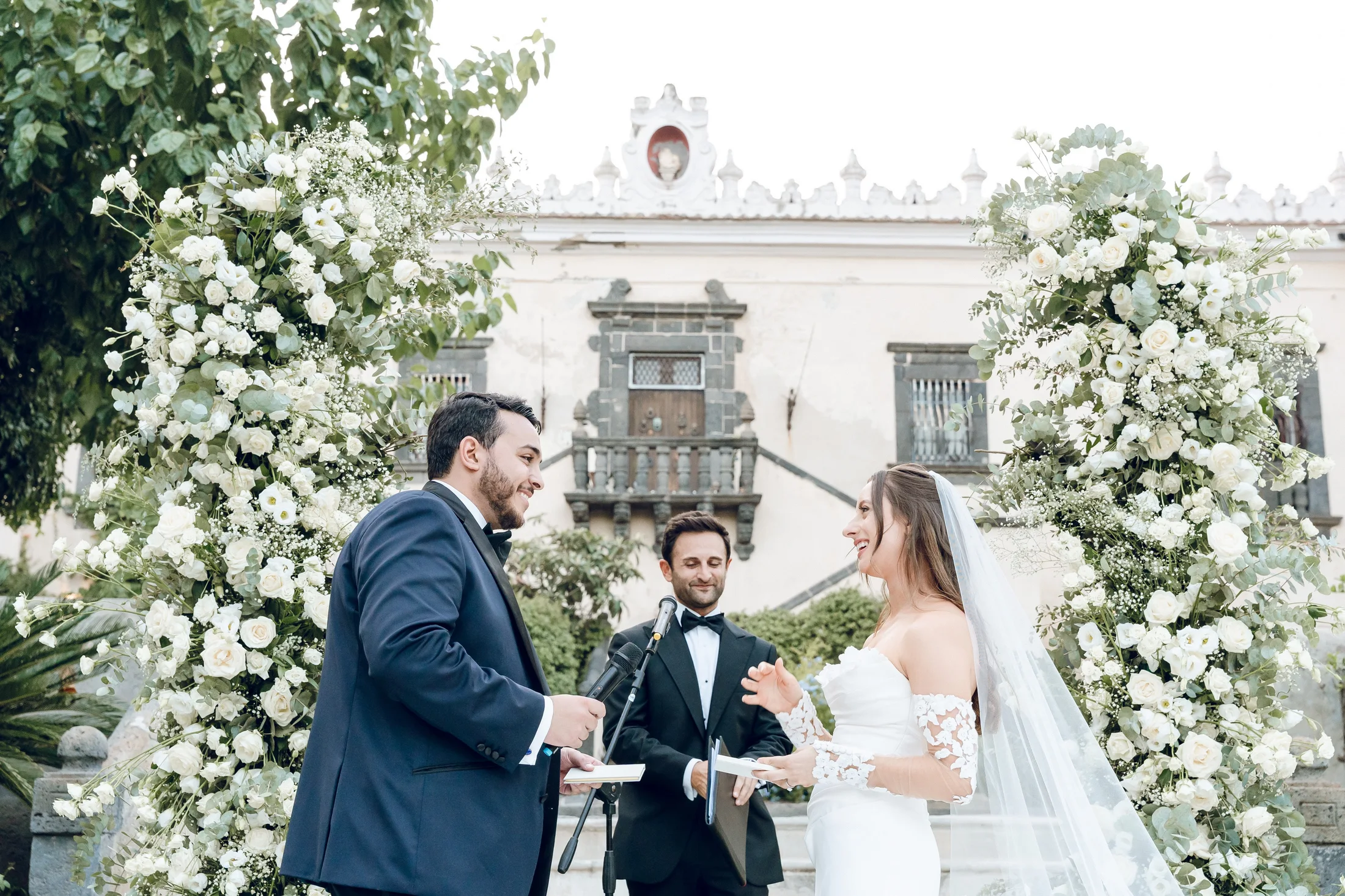 Bride and groom exchanging vows outdoors