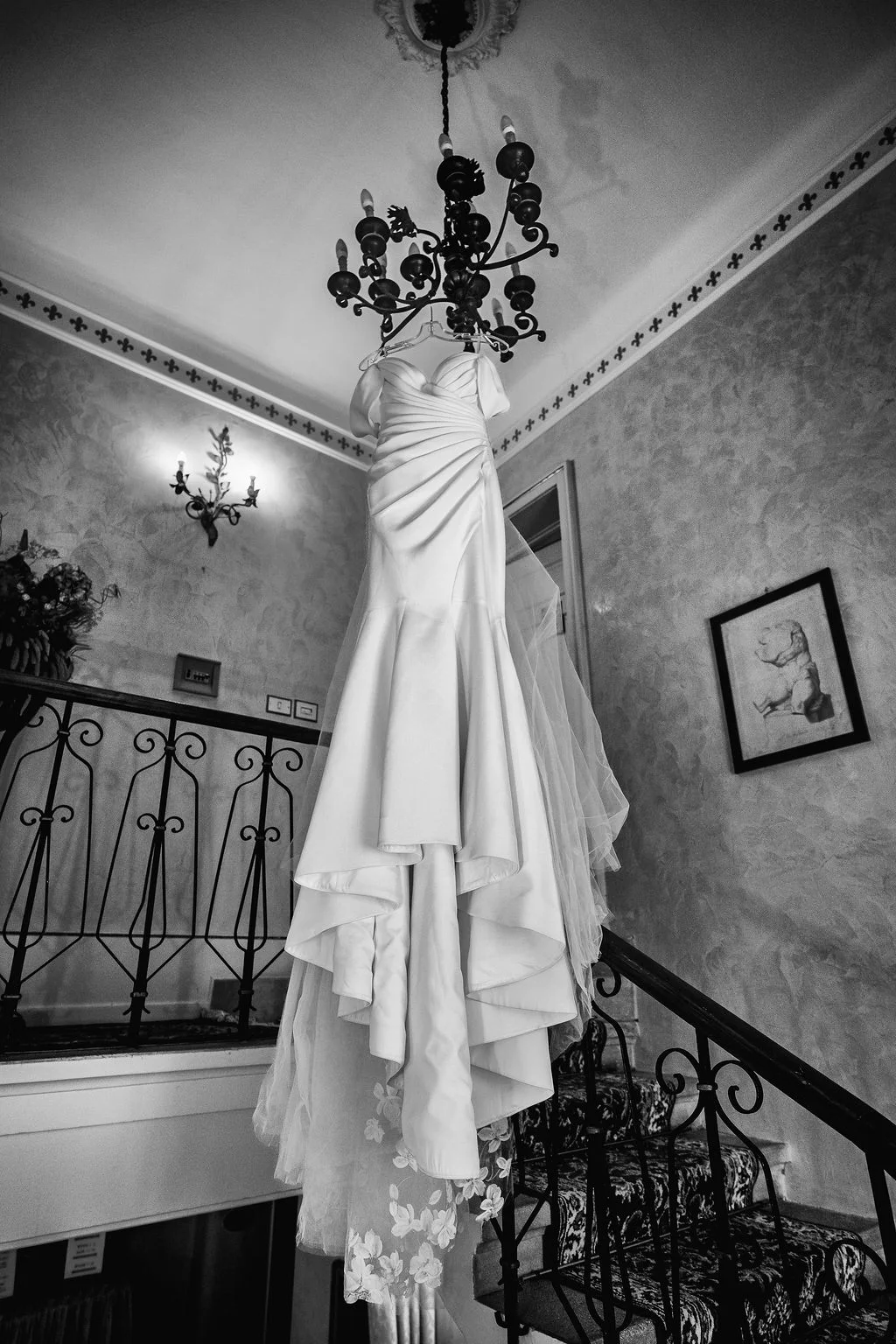 Black-and-white bridal dress photograph on a staircase