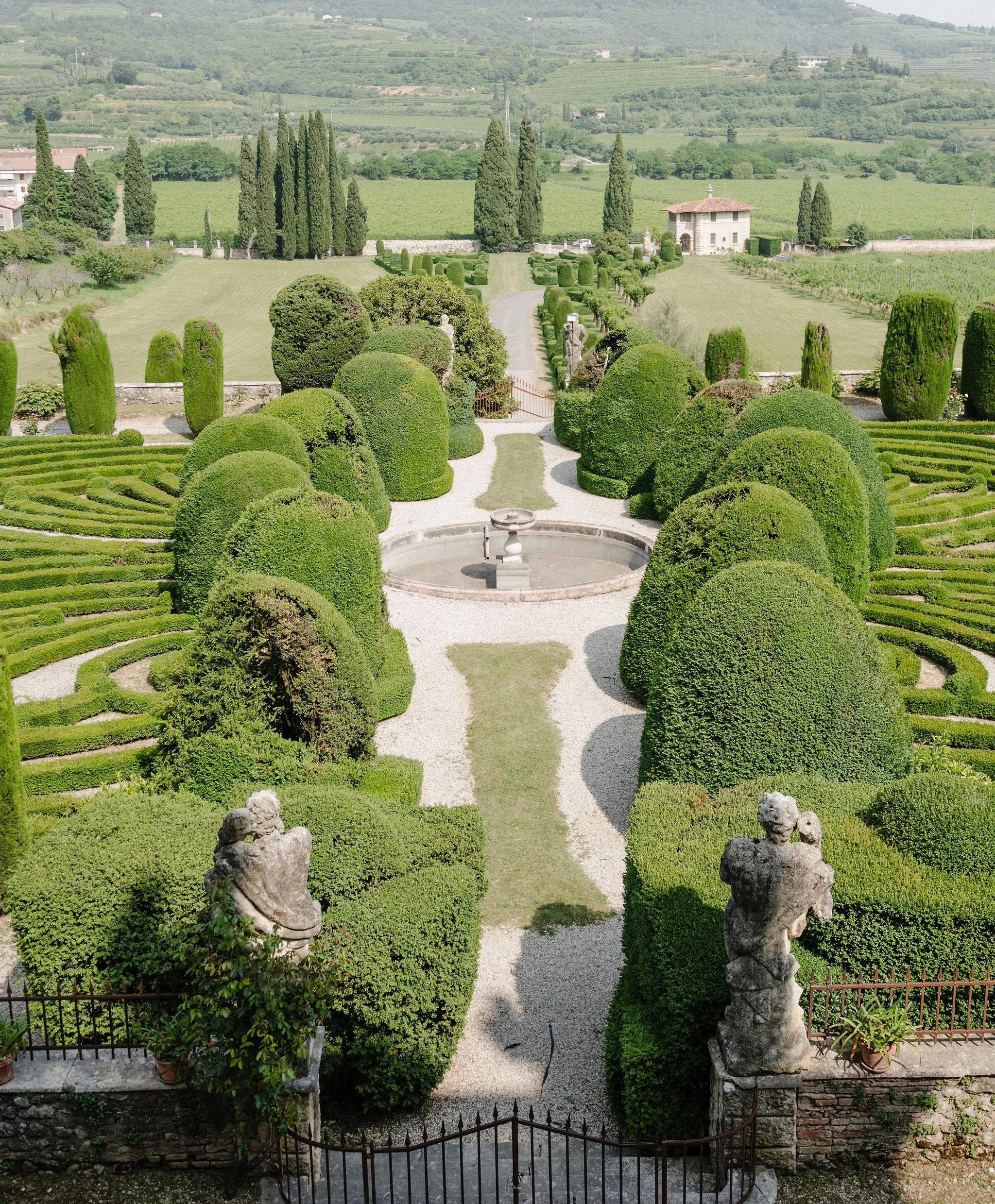 Formal gardens viewed from a stone terrace