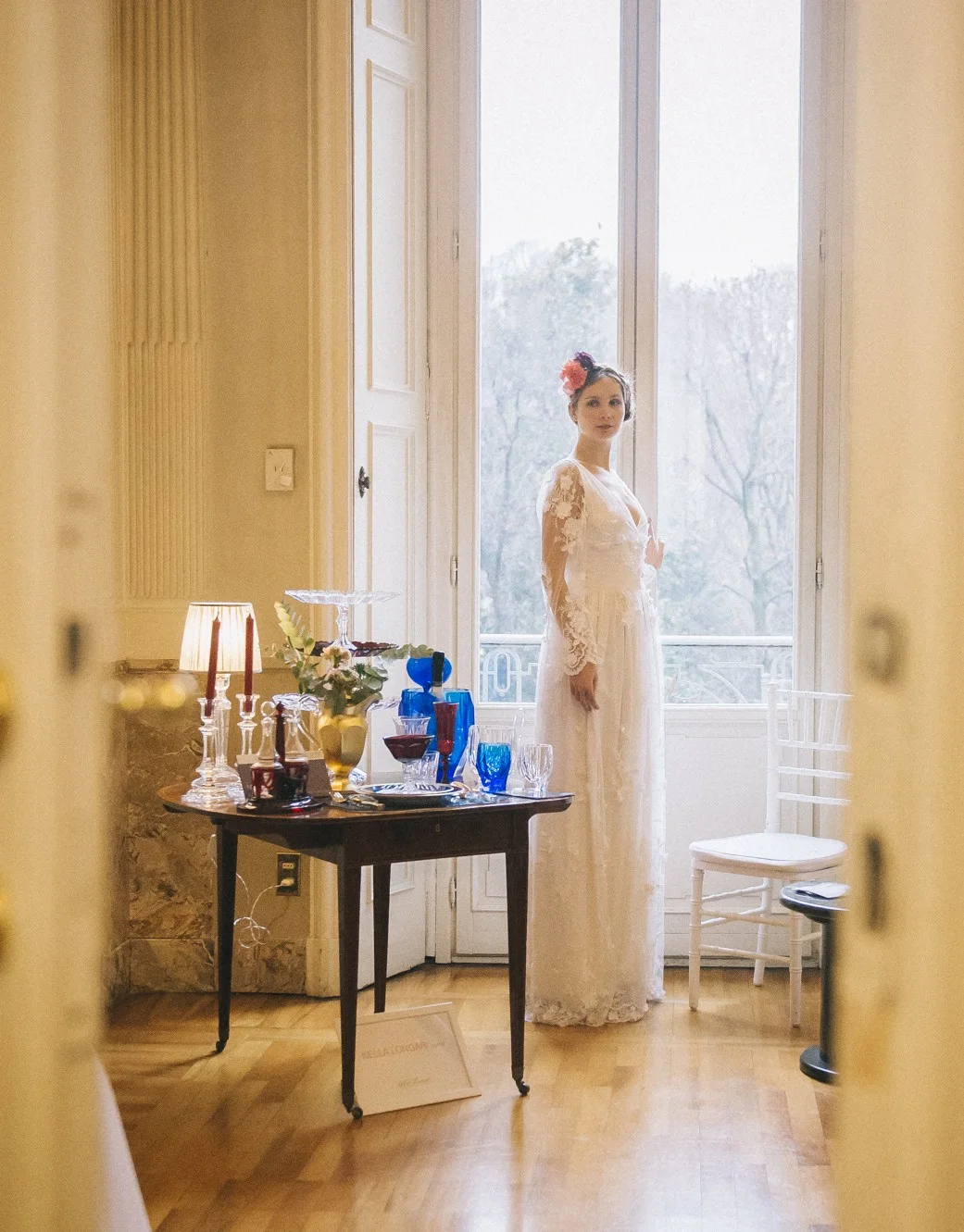Bride beside an open window in a decorated room