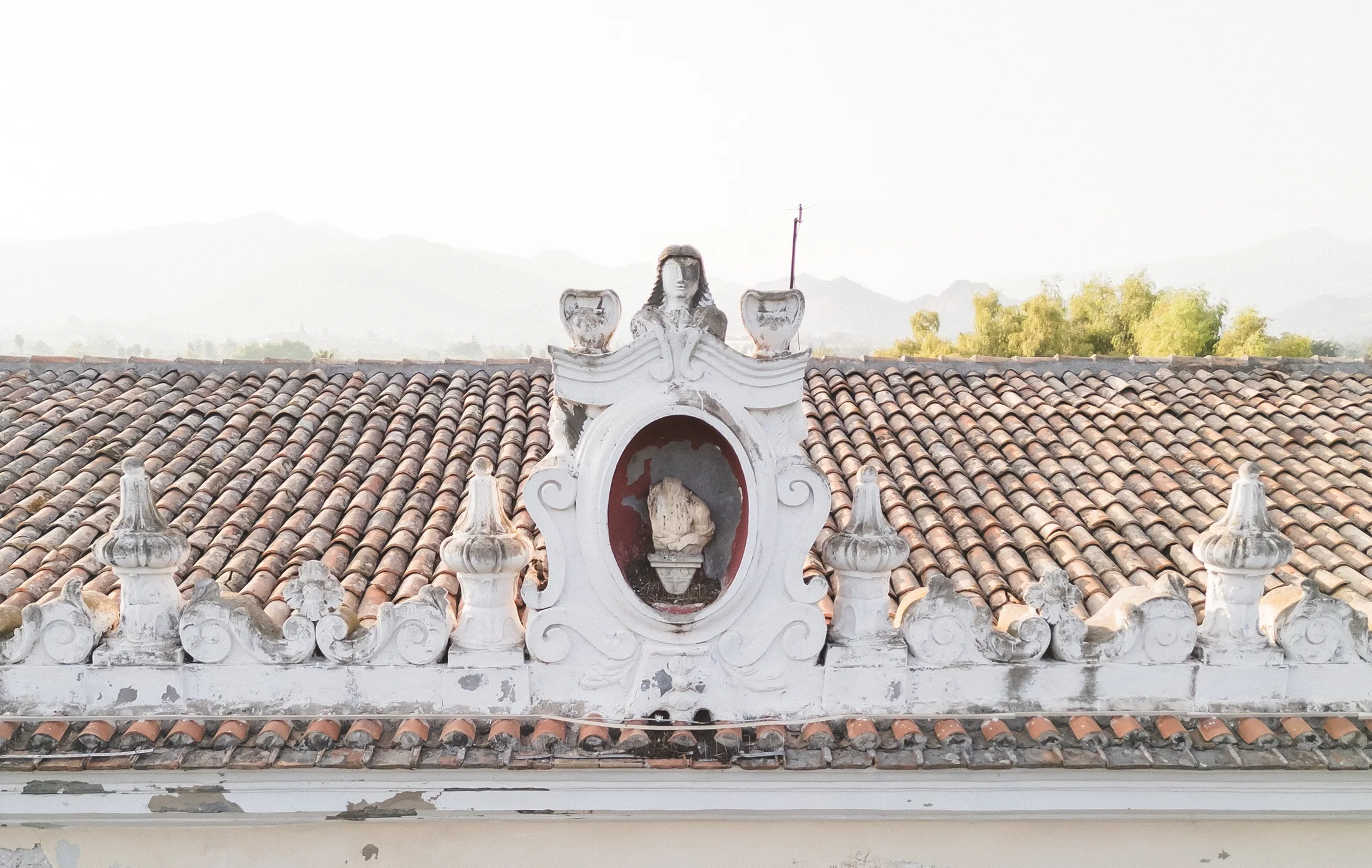Decorative crest on a tiled villa roof