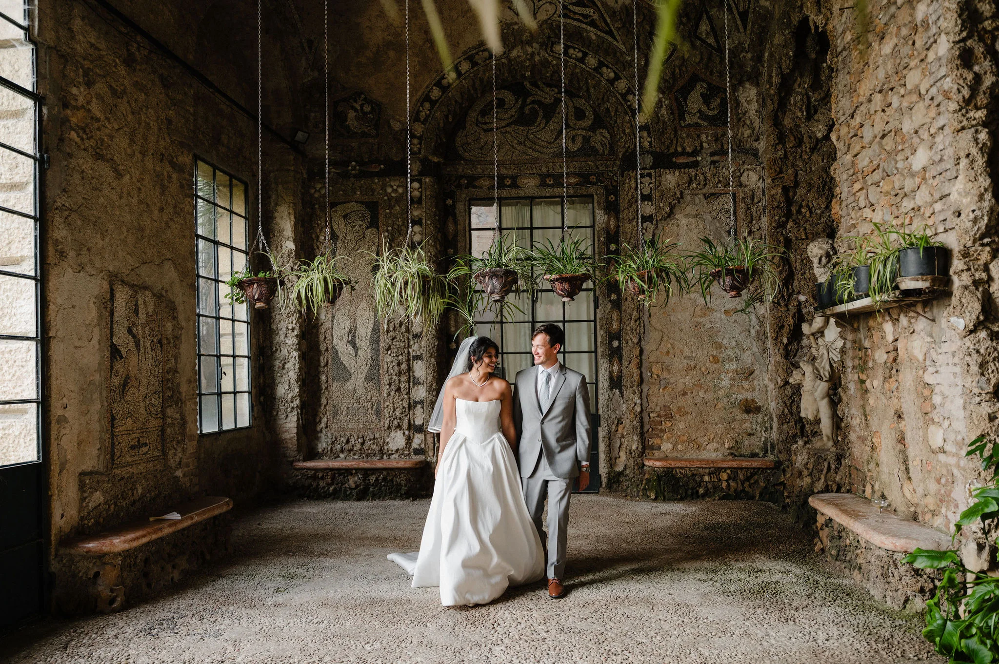 Bride and groom in a weathered stone interior