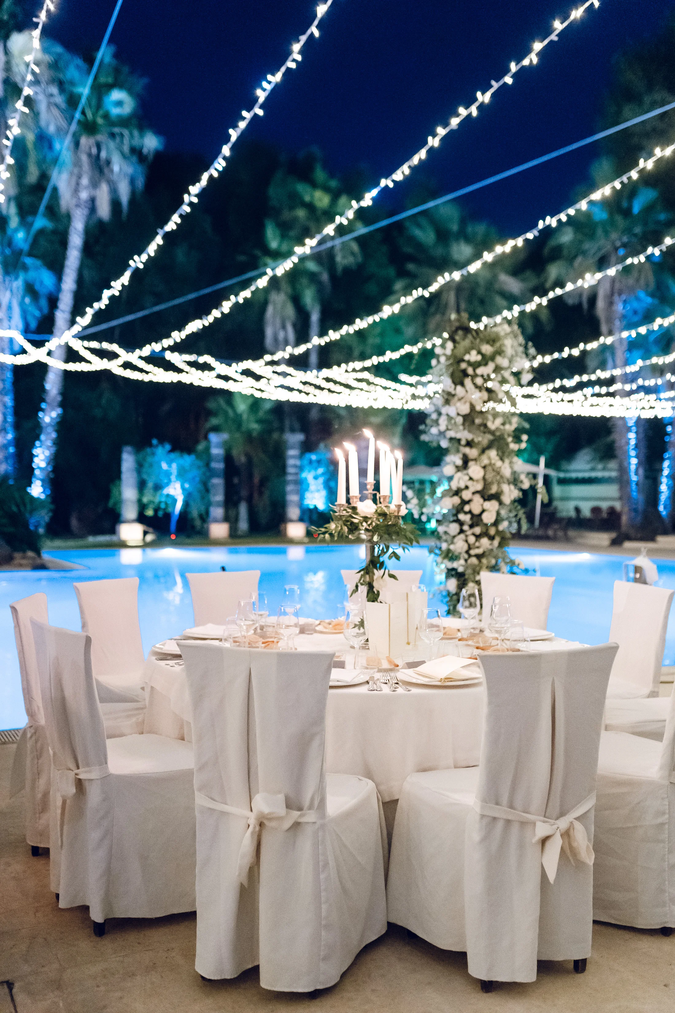 Evening reception tables under strings of lights
