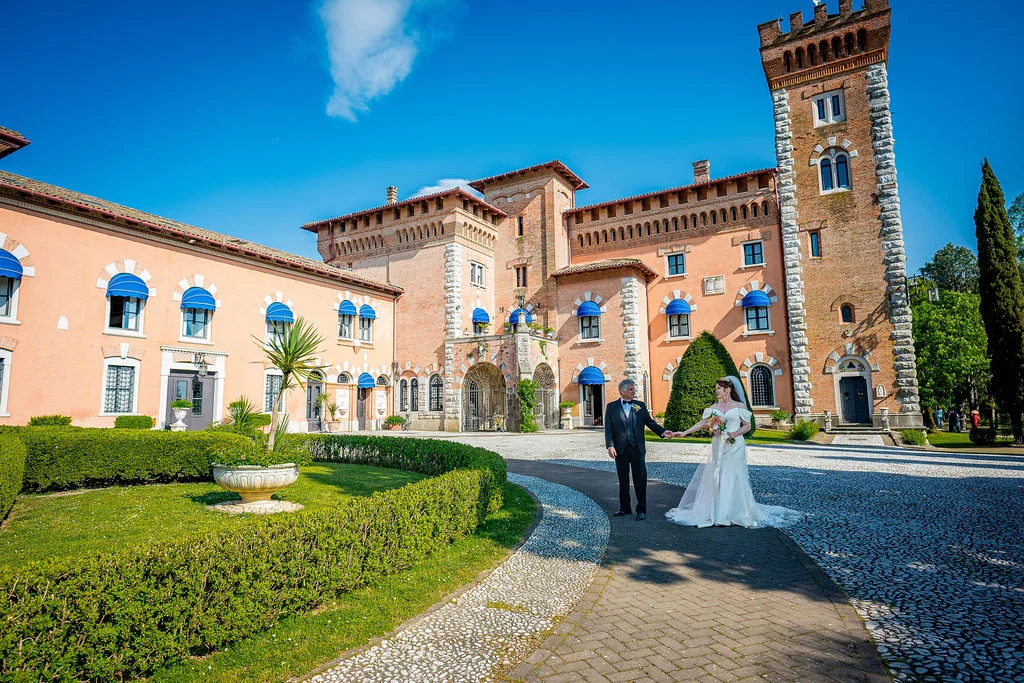 Bride and groom outside a brick castle