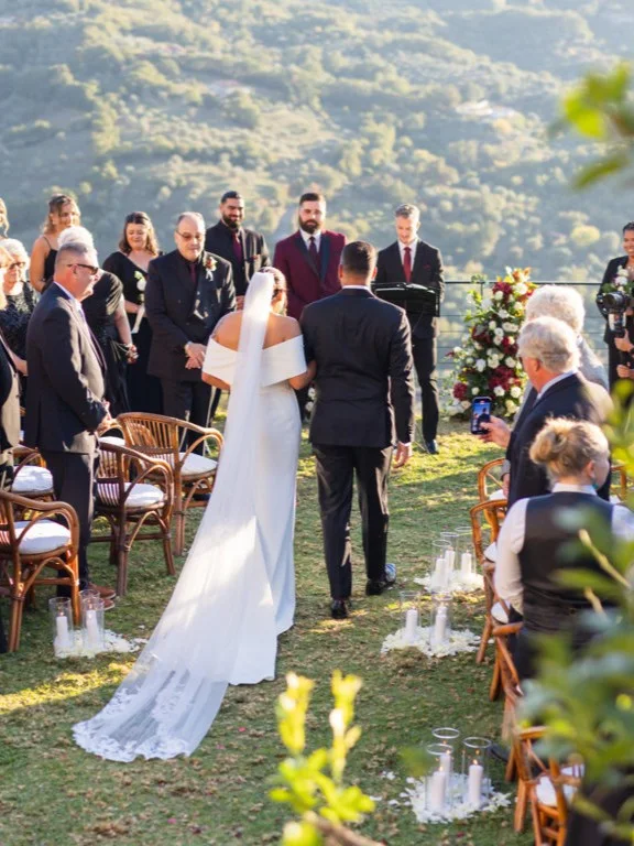Guests watching an outdoor wedding ceremony