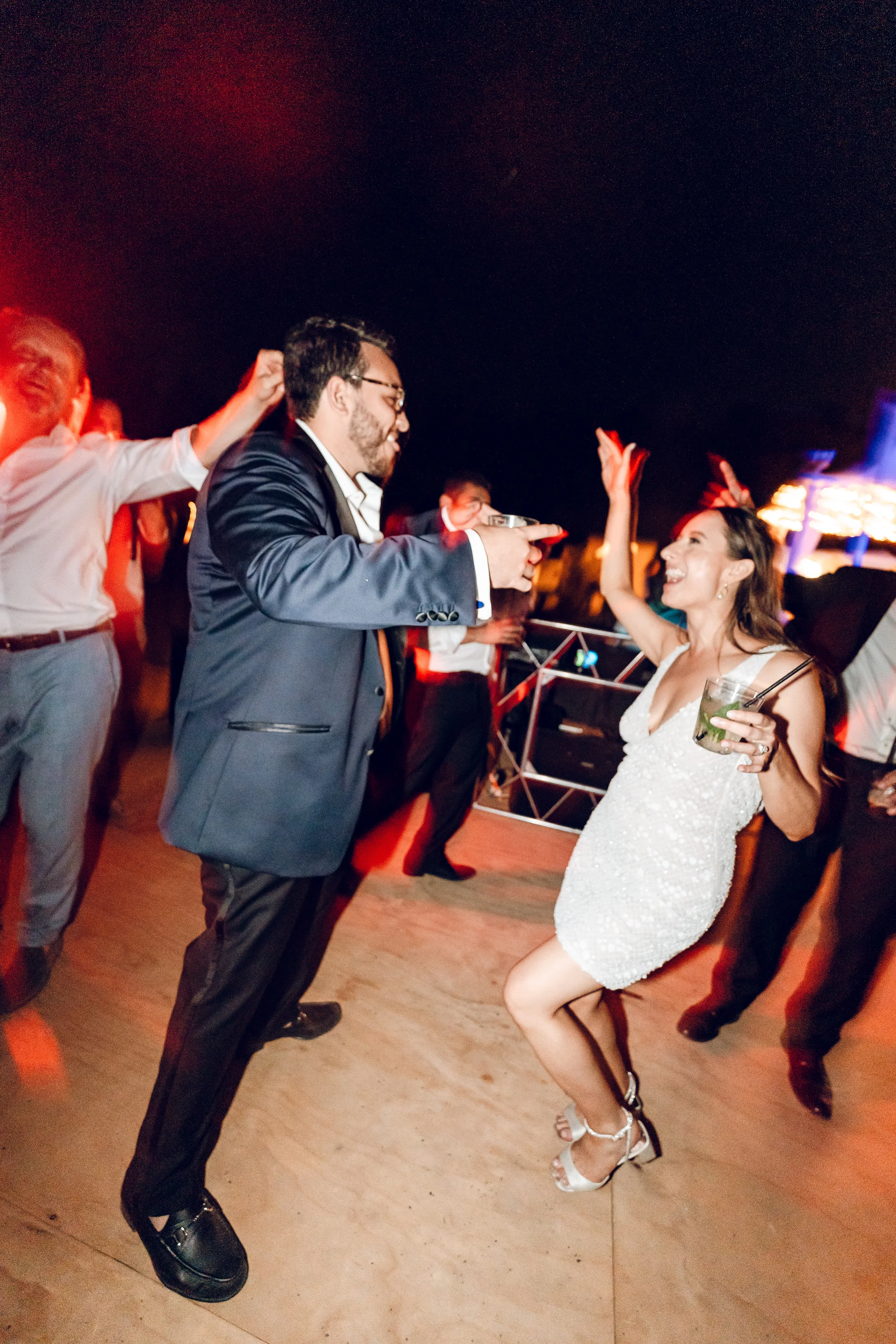 Guests dancing under coloured lights