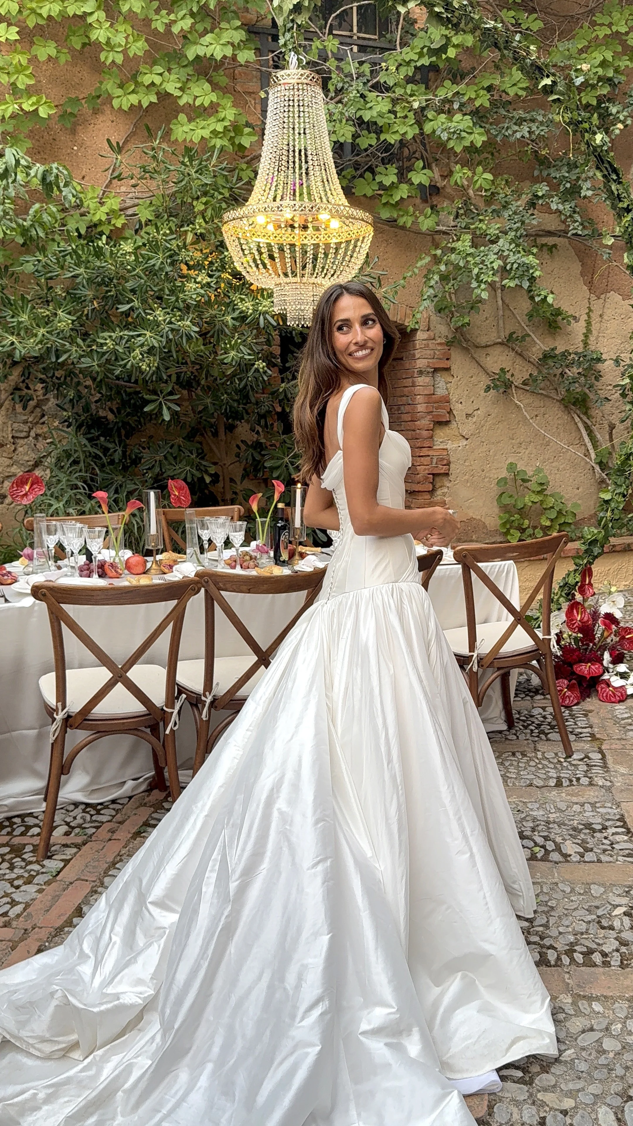 Bride beside a reception table in a courtyard