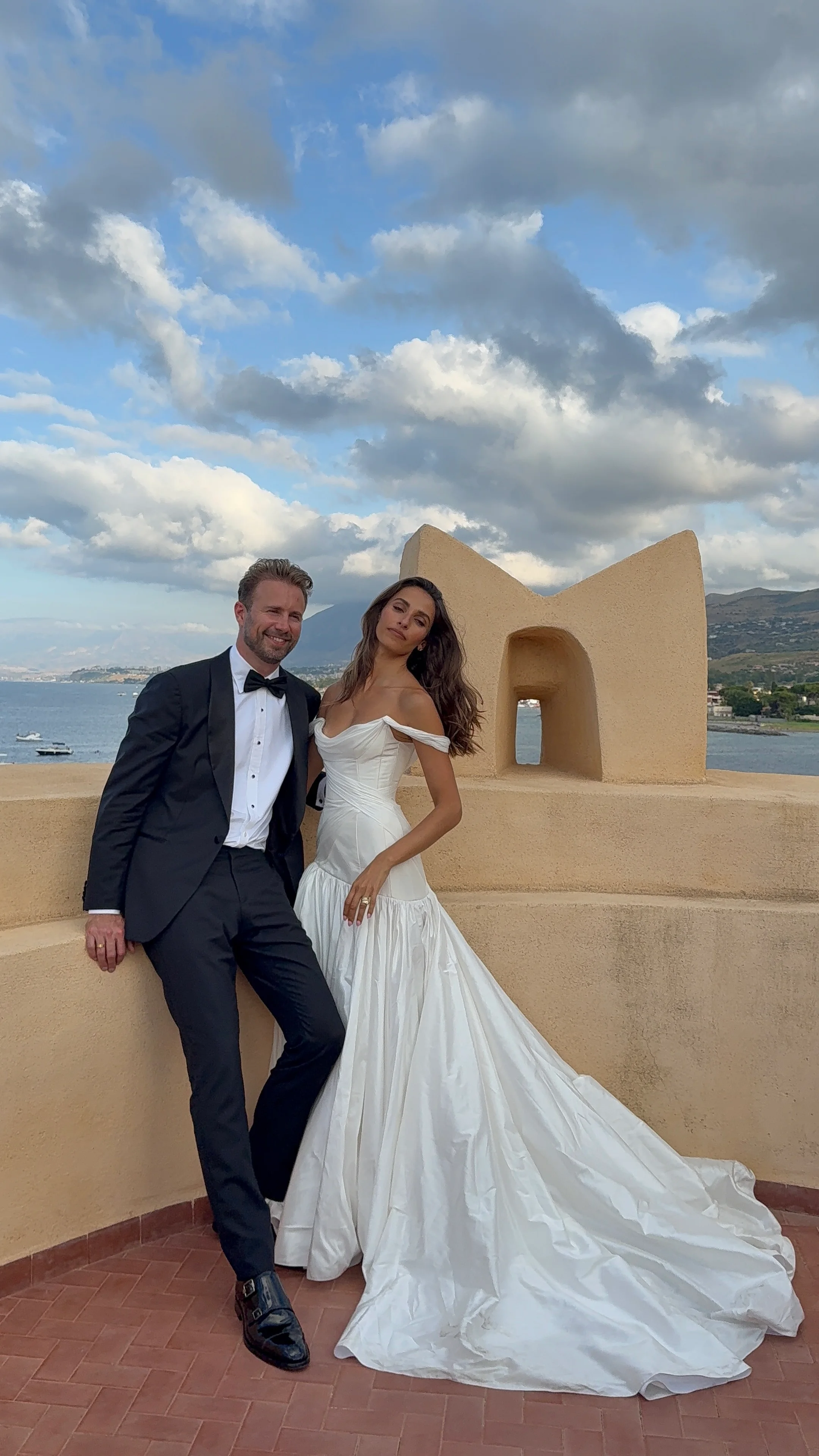Bride and groom on a seaside castle terrace