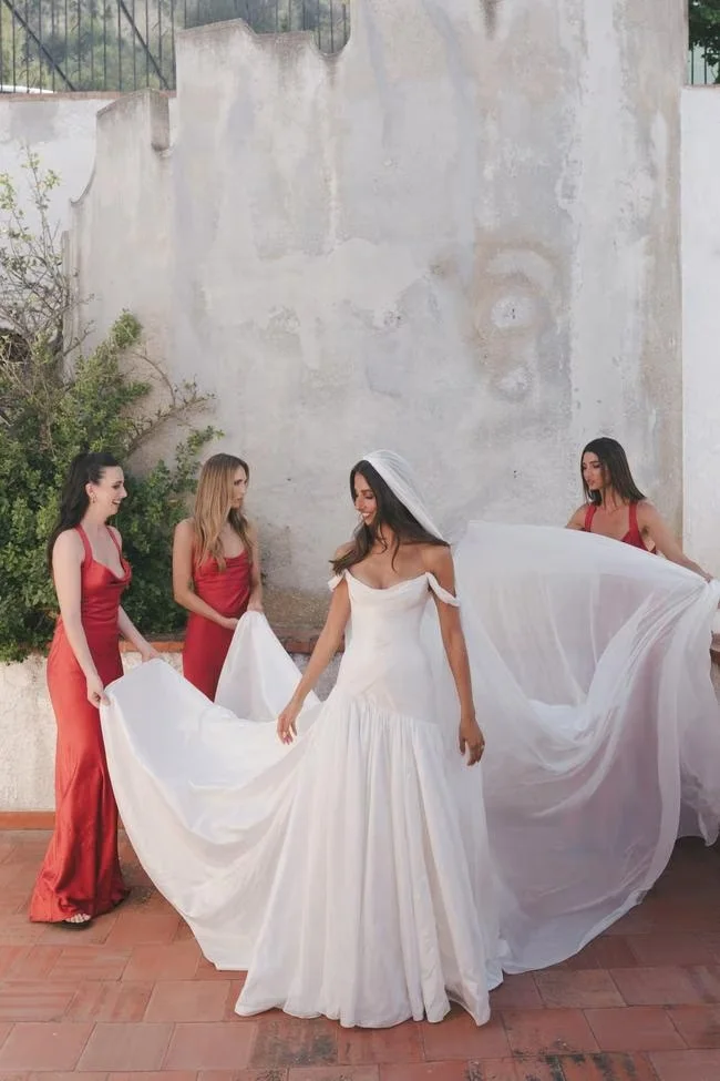 Bride being helped with her dress indoors
