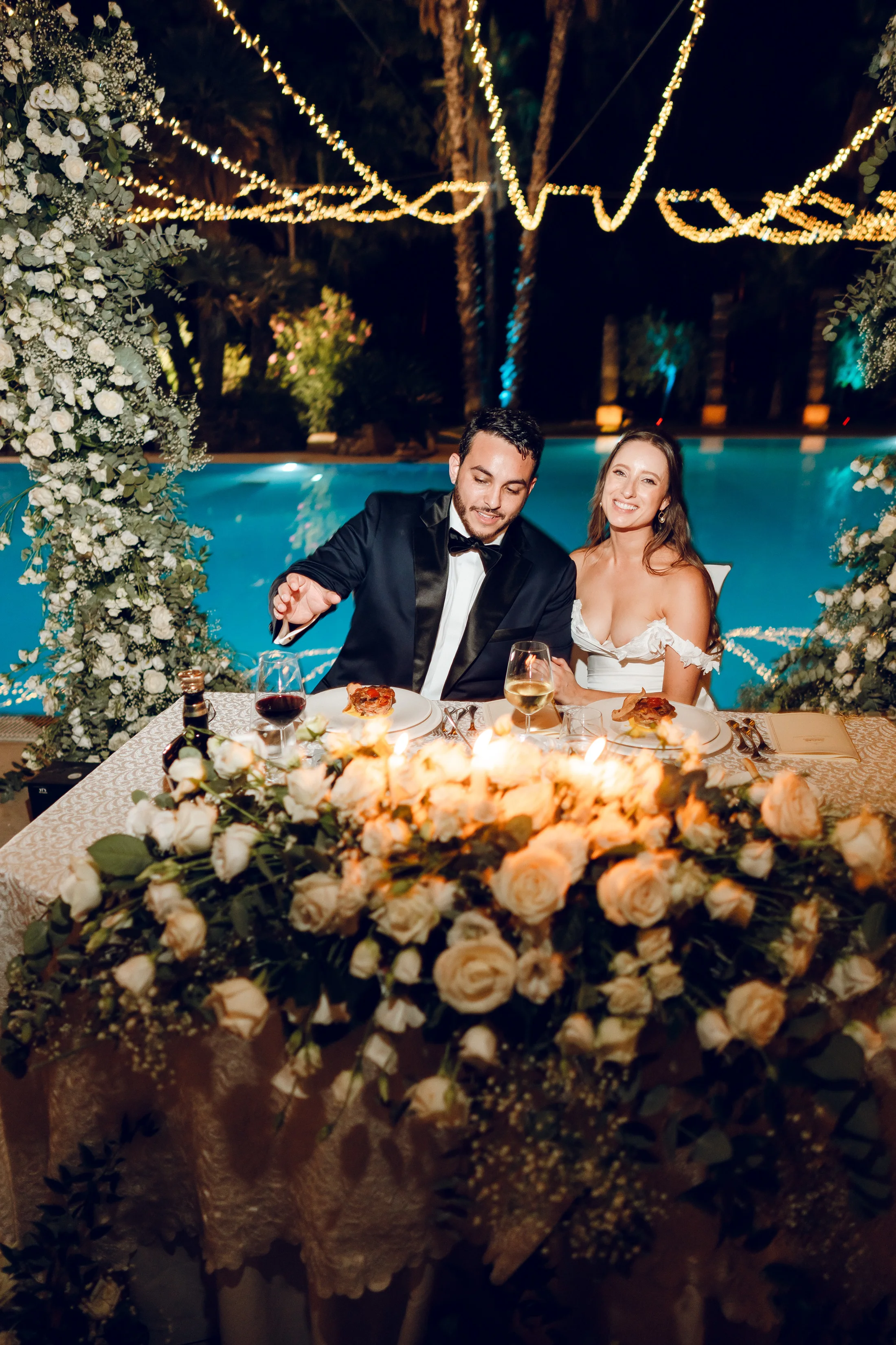 Bride and groom seated at their reception table