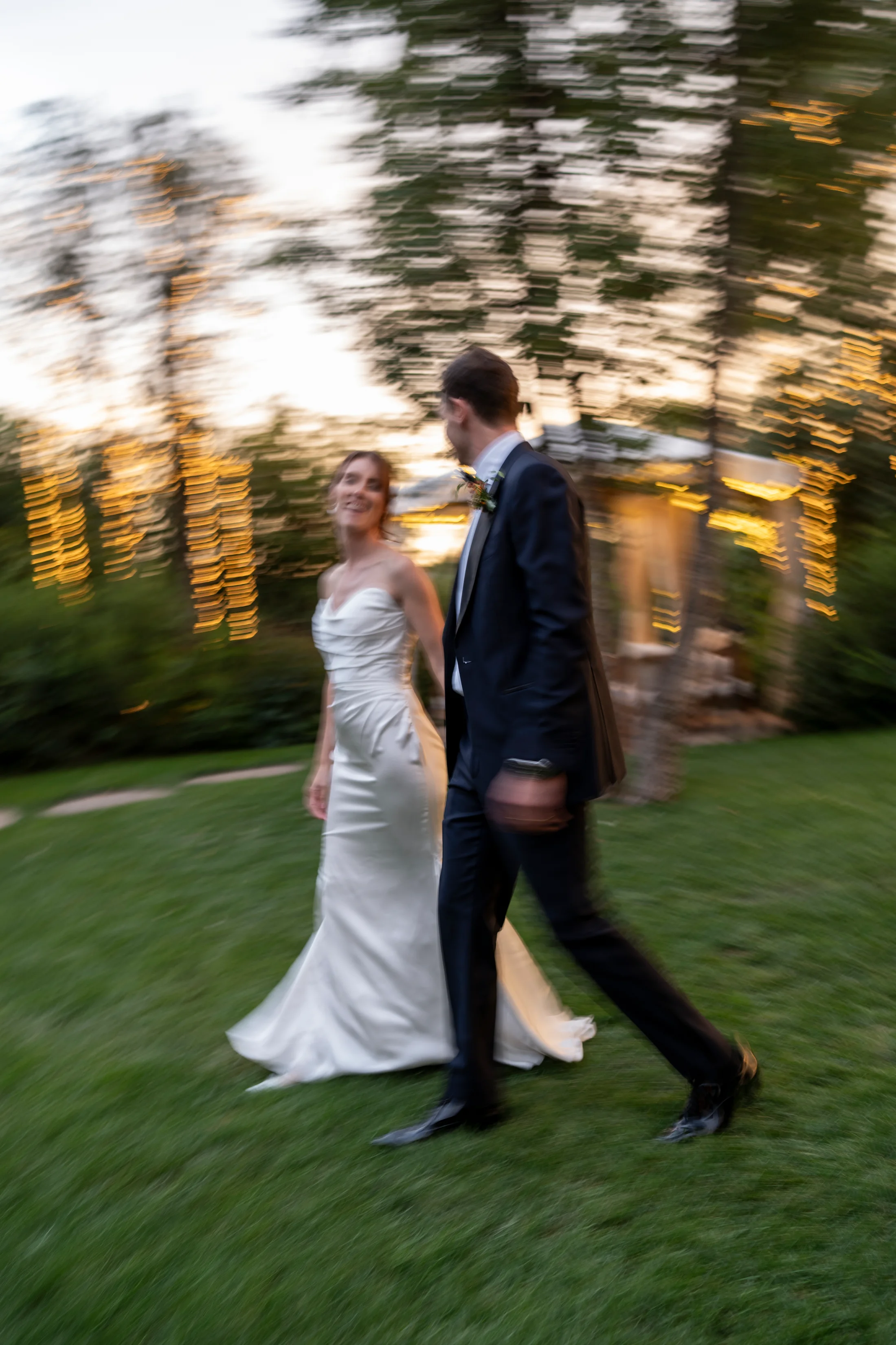 Bride and groom walking through a garden
