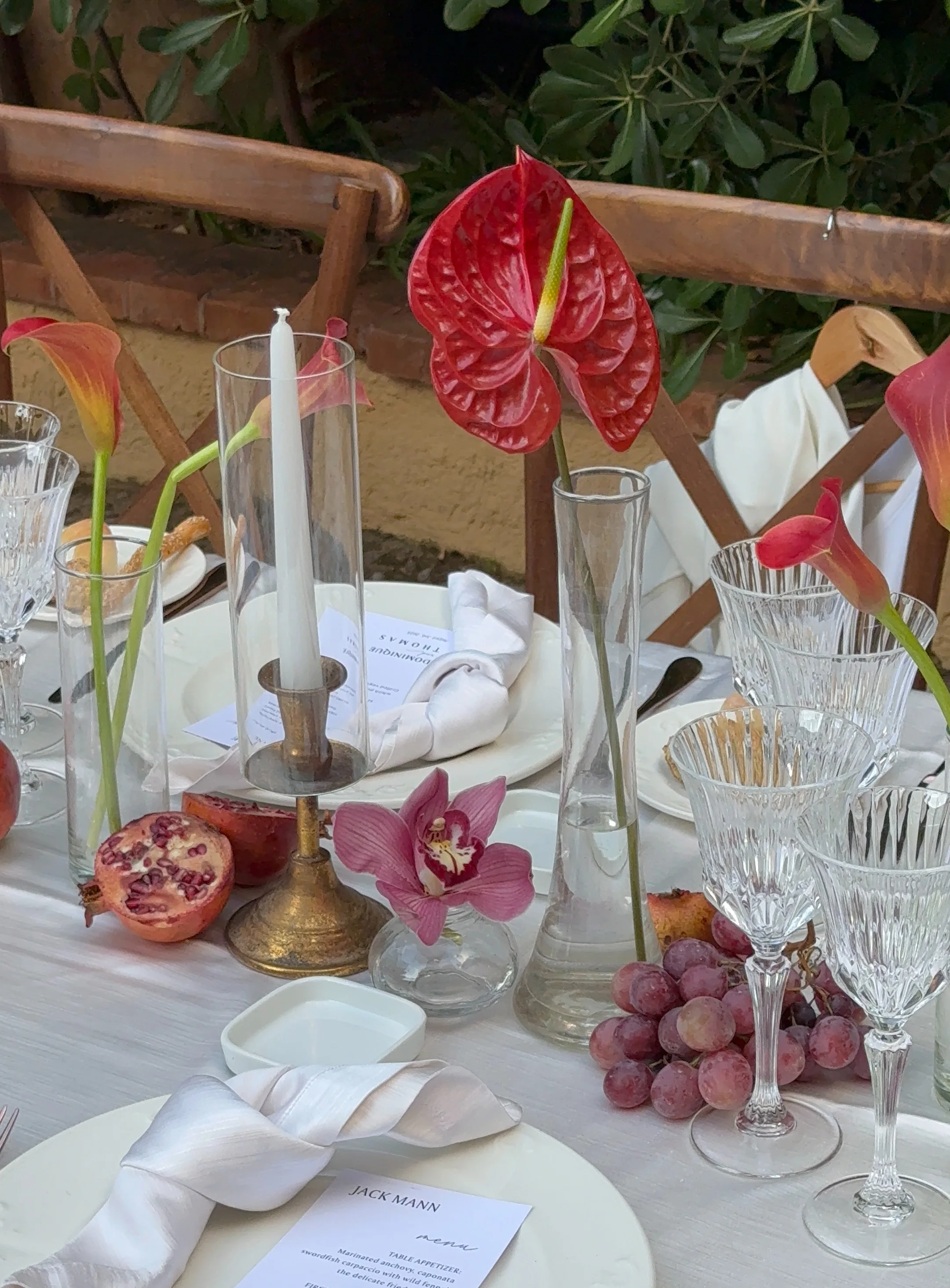 Reception table with red anthuriums and green fruit