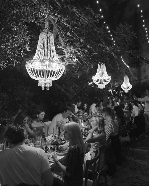 Black-and-white reception beneath hanging chandeliers